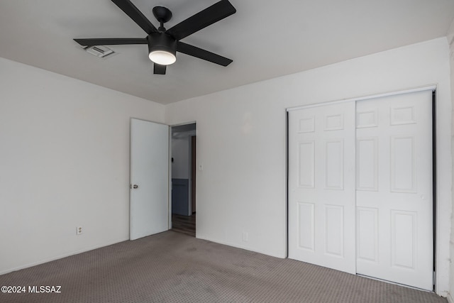 unfurnished bedroom featuring ceiling fan, carpet floors, and a closet