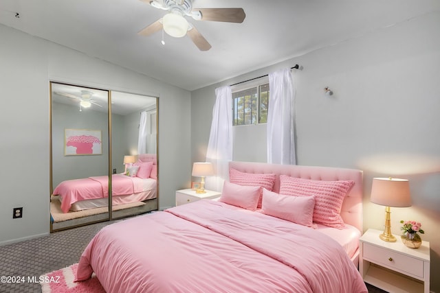 bedroom with carpet flooring, ceiling fan, vaulted ceiling, and a closet