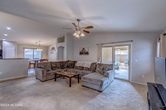 living room with ceiling fan, lofted ceiling, and light carpet