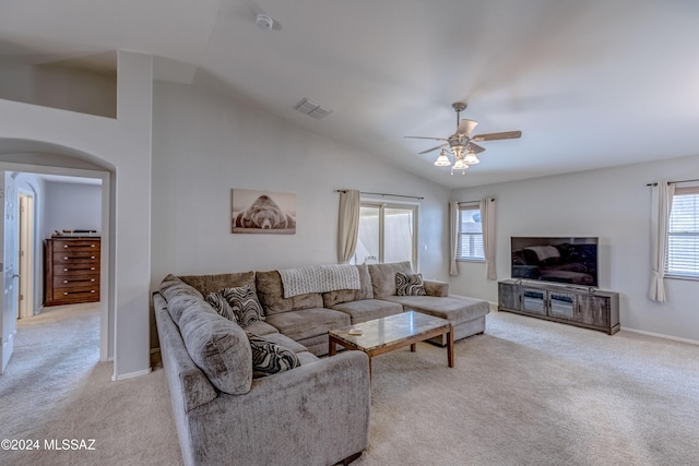 living room featuring ceiling fan, light colored carpet, and vaulted ceiling