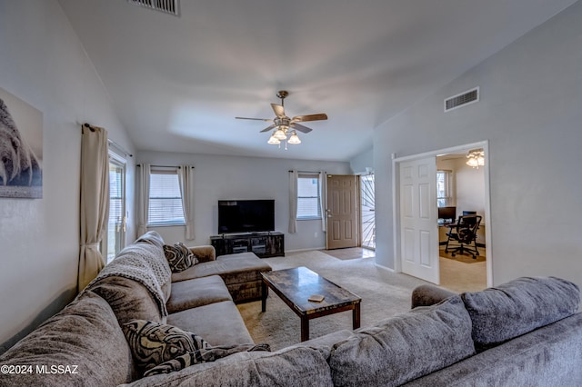 living room featuring light carpet, lofted ceiling, ceiling fan, and a healthy amount of sunlight