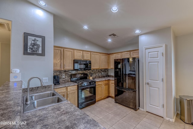 kitchen with backsplash, sink, black appliances, light tile patterned floors, and lofted ceiling