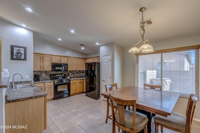 kitchen with vaulted ceiling, sink, black appliances, pendant lighting, and light tile patterned floors