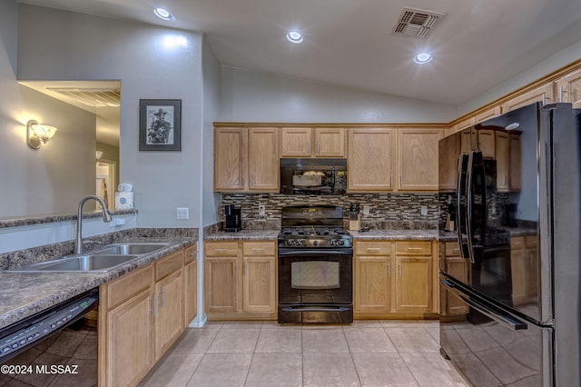 kitchen with tasteful backsplash, vaulted ceiling, sink, black appliances, and light tile patterned floors