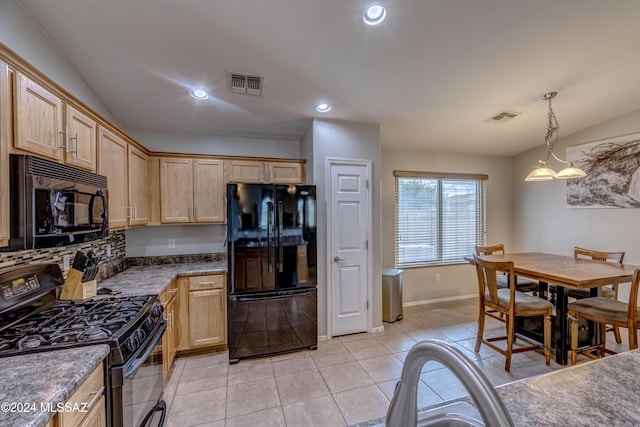 kitchen featuring light brown cabinets, hanging light fixtures, lofted ceiling, and black appliances