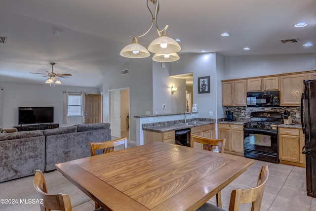 dining space with ceiling fan, light tile patterned floors, sink, and high vaulted ceiling