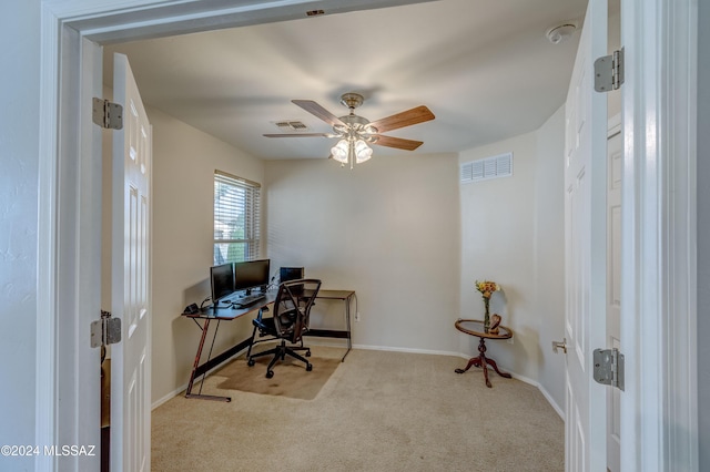 carpeted home office featuring ceiling fan