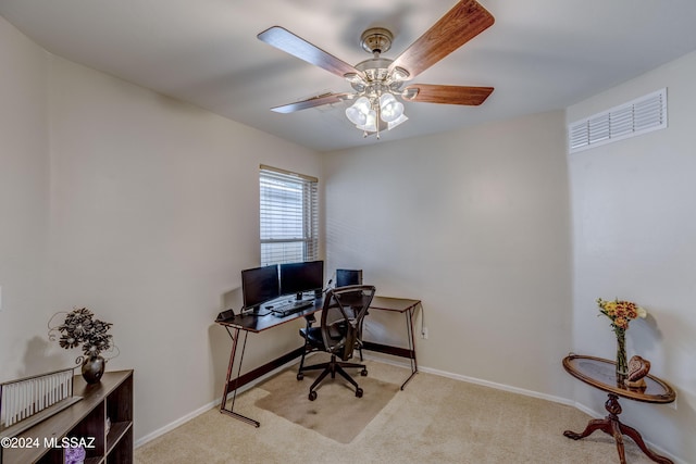 carpeted home office featuring ceiling fan