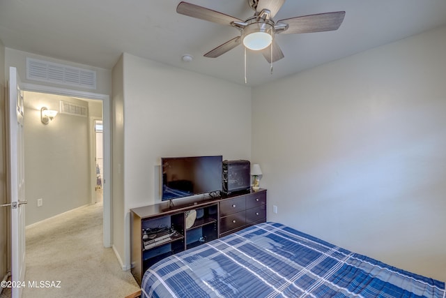 bedroom featuring light carpet and ceiling fan