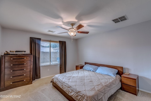 bedroom with ceiling fan and light carpet