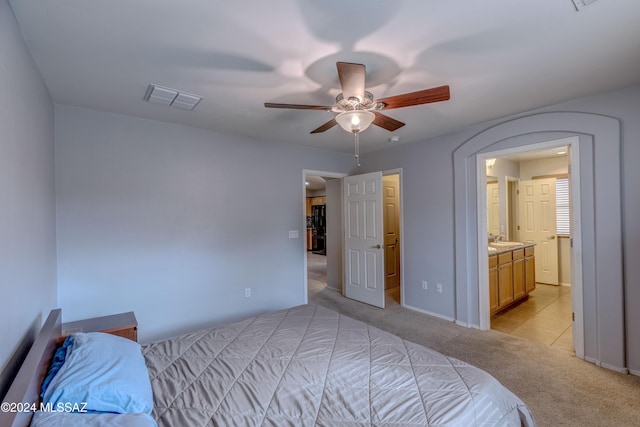 carpeted bedroom featuring connected bathroom and ceiling fan