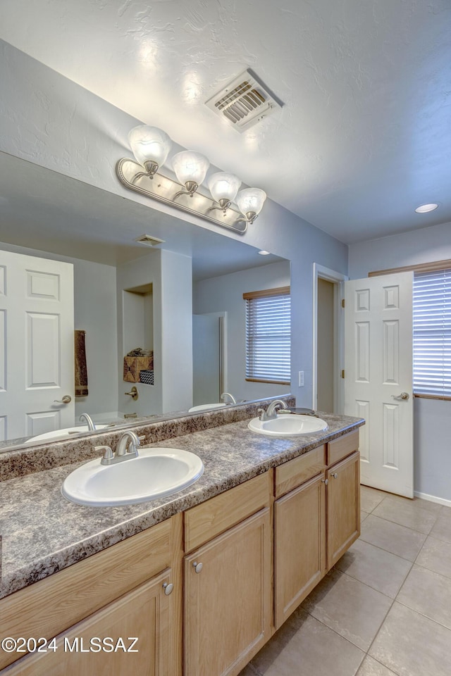 bathroom featuring tile patterned flooring and vanity