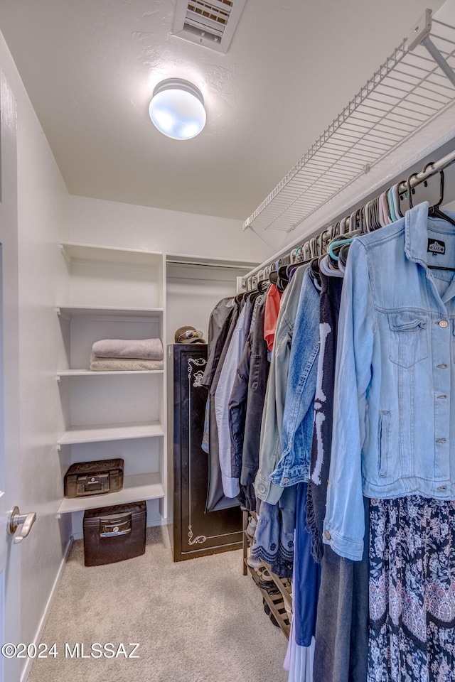 walk in closet with carpet flooring