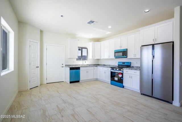 kitchen featuring dark hardwood / wood-style floors, white cabinetry, sink, and hanging light fixtures