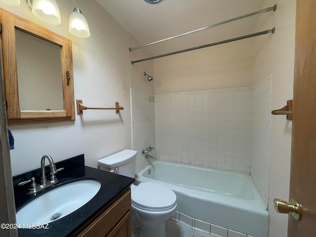 full bathroom with vanity, tiled shower / bath, and toilet