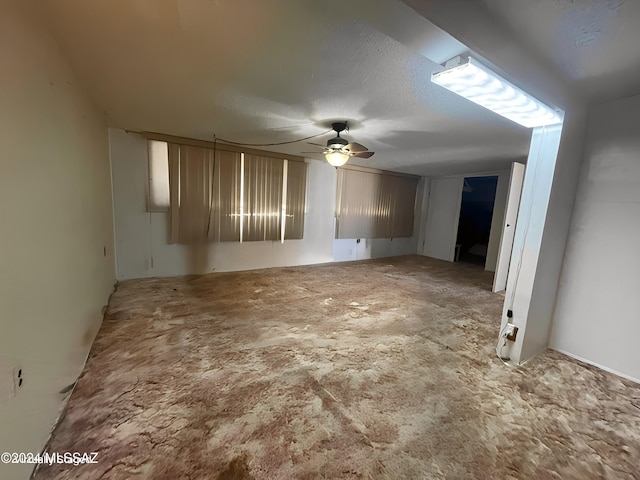 empty room featuring a textured ceiling and ceiling fan