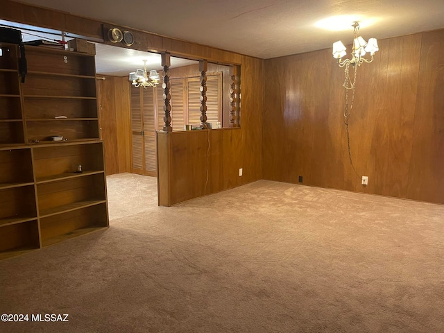 interior space featuring an inviting chandelier and wood walls