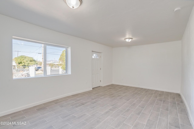 empty room featuring light wood-style flooring and baseboards