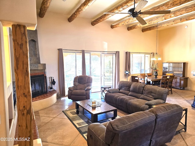 tiled living room with beamed ceiling and ceiling fan with notable chandelier