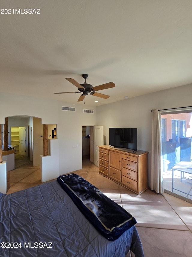 tiled bedroom featuring ceiling fan and access to exterior