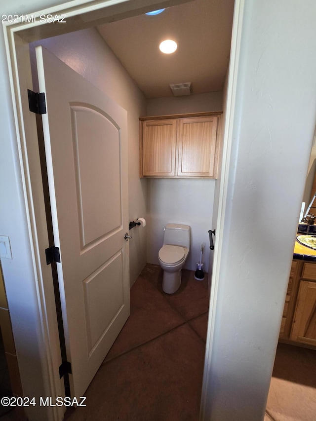 bathroom with toilet and tile patterned floors