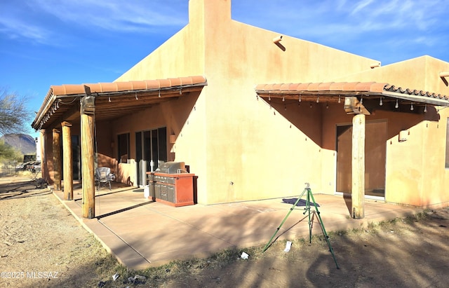 back of property featuring a patio area