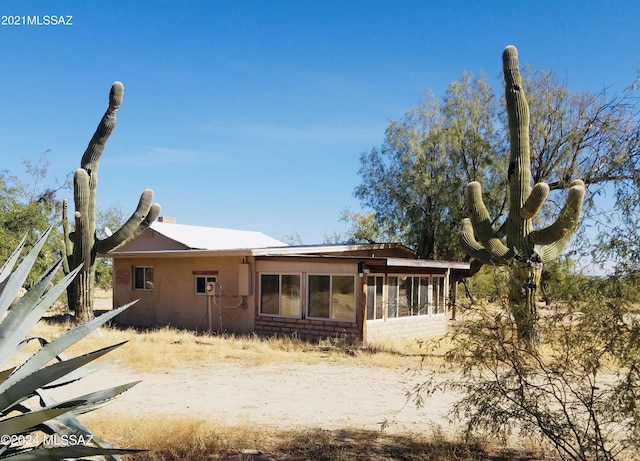 back of property featuring a sunroom