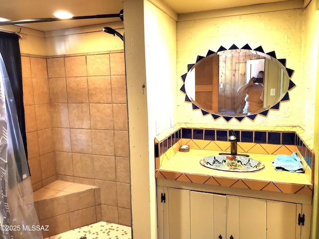 bathroom with a shower and vanity