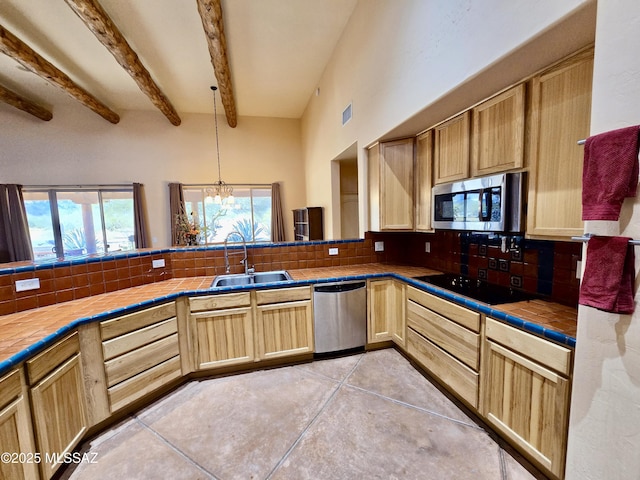 kitchen with tasteful backsplash, tile countertops, sink, stainless steel appliances, and light tile patterned floors