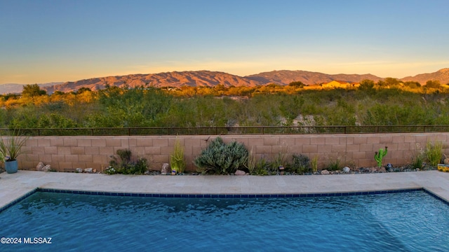 pool at dusk with a mountain view