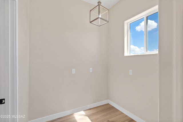 67620 E Lauren Pl, Oracle, AZ 85623 - unfurnished dining area with baseboards and light wood-style floors