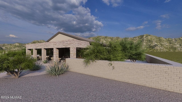 view of home's exterior featuring a mountain view and a patio