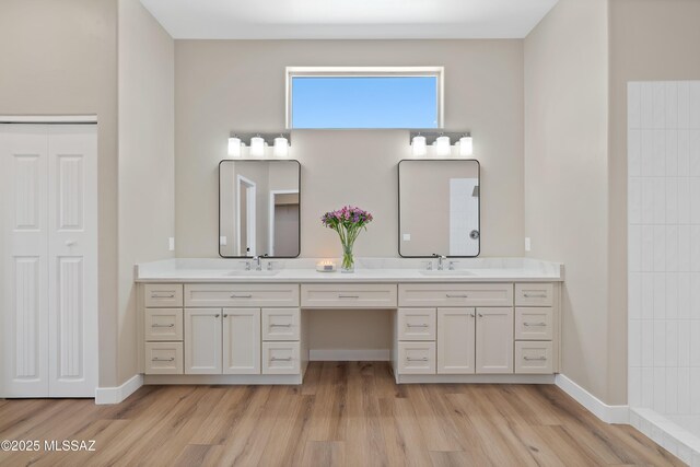 67620 E Lauren Pl, Oracle, AZ 85623 - bathroom with double vanity, wood finished floors, and baseboards
