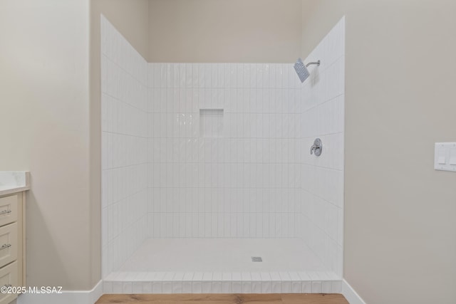 67620 E Lauren Pl, Oracle, AZ 85623 - bathroom featuring tiled shower, vanity, and baseboards