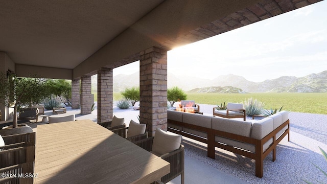 view of patio / terrace with a mountain view and an outdoor living space