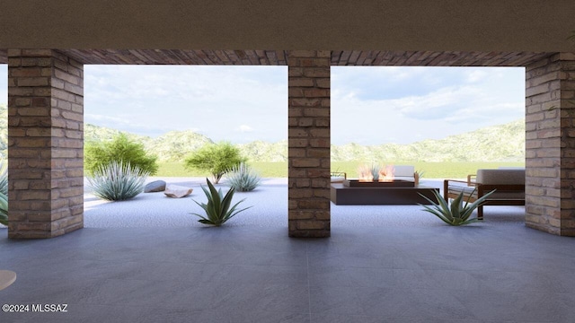 view of patio / terrace featuring an outdoor living space with a fire pit