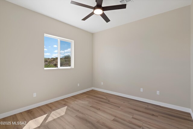 67620 E Lauren Pl, Oracle, AZ 85623 - empty room with ceiling fan, light wood finished floors, and baseboards