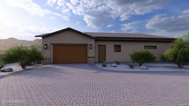 view of front of property with a garage and a mountain view