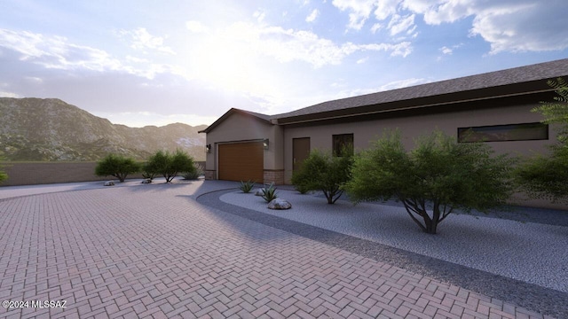 view of front of house featuring a garage and a mountain view