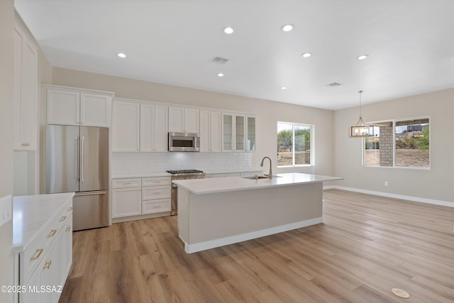 67620 E Lauren Pl, Oracle, AZ 85623 - kitchen with high quality appliances, light wood-style flooring, backsplash, white cabinetry, and recessed lighting