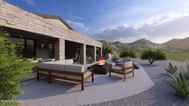 view of patio / terrace featuring an outdoor living space with a fire pit and a mountain view