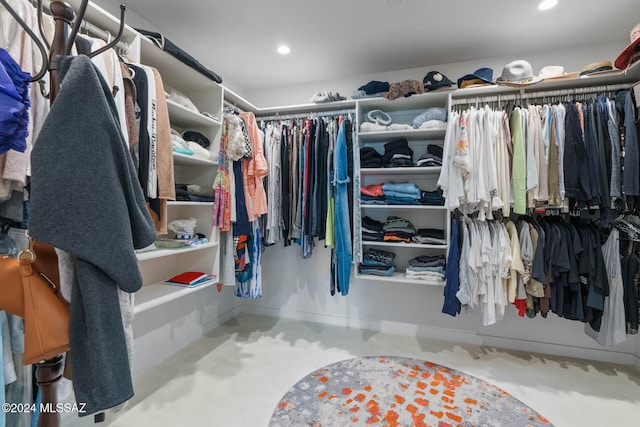 walk in closet featuring carpet flooring