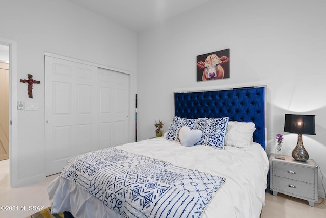 bedroom with light colored carpet and a closet