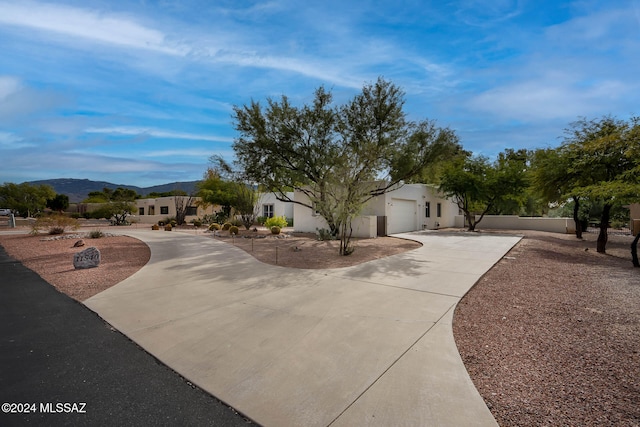 view of front of home with a mountain view and a garage