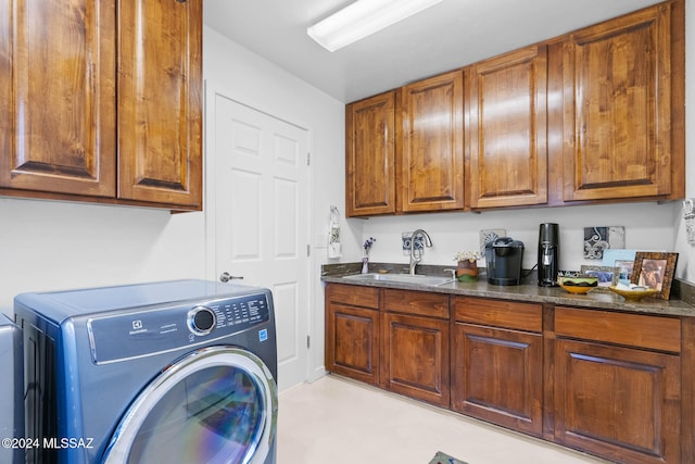 laundry room featuring cabinets, sink, and washer / clothes dryer