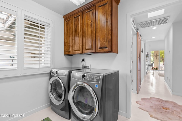 laundry room featuring cabinets and washer and clothes dryer