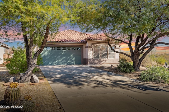 mediterranean / spanish house featuring a garage