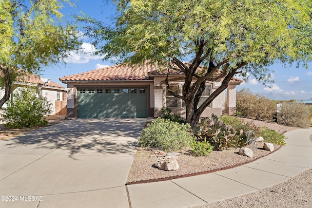 mediterranean / spanish-style home with a garage