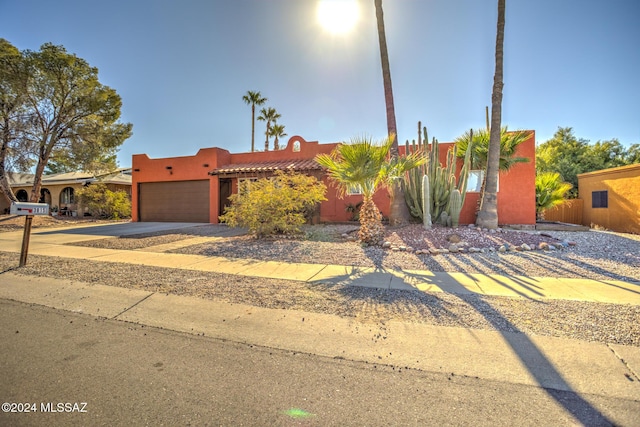 pueblo-style home featuring a garage