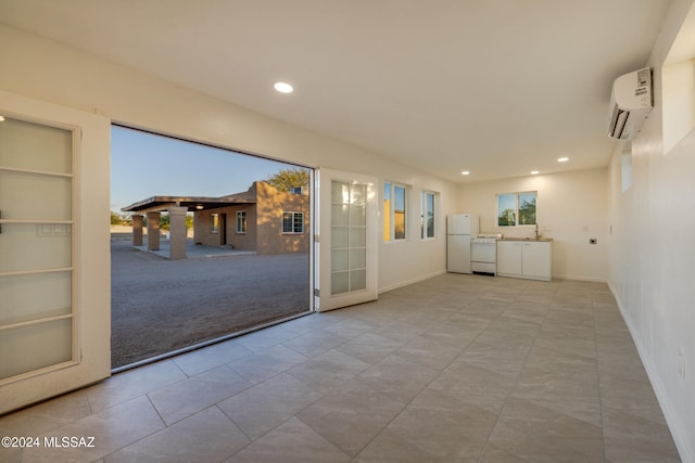 unfurnished room with built in shelves, light colored carpet, a wall unit AC, and a wealth of natural light